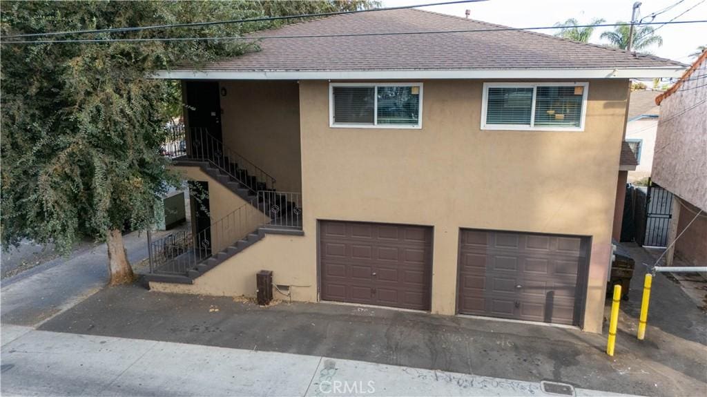 view of front of property with cooling unit and a garage