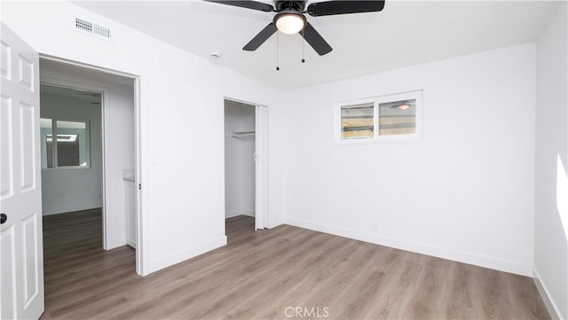 unfurnished bedroom with ceiling fan, a closet, and light hardwood / wood-style flooring