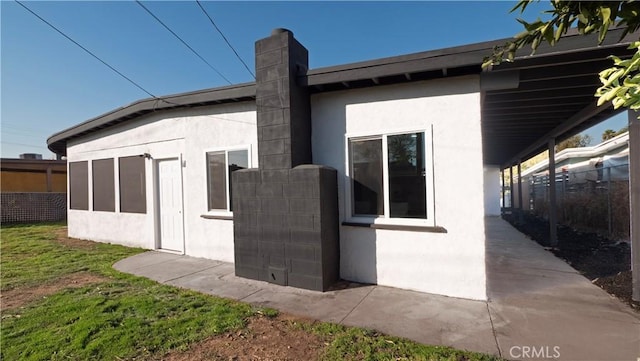 view of side of home featuring a yard