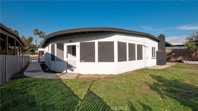 rear view of house featuring a yard