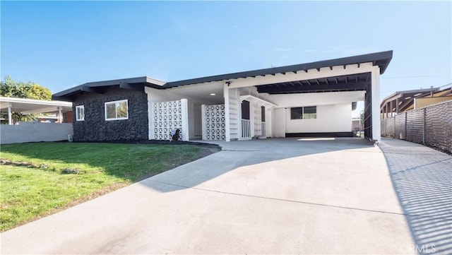 view of front of house with a front yard and a carport