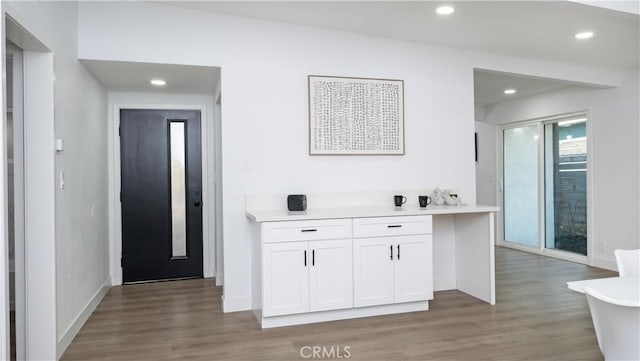 kitchen with white cabinetry and hardwood / wood-style floors