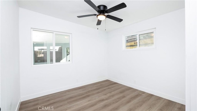 spare room with ceiling fan and wood-type flooring