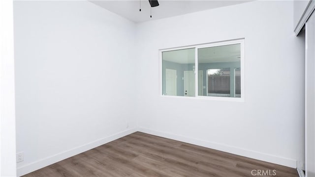 empty room with ceiling fan and dark hardwood / wood-style floors