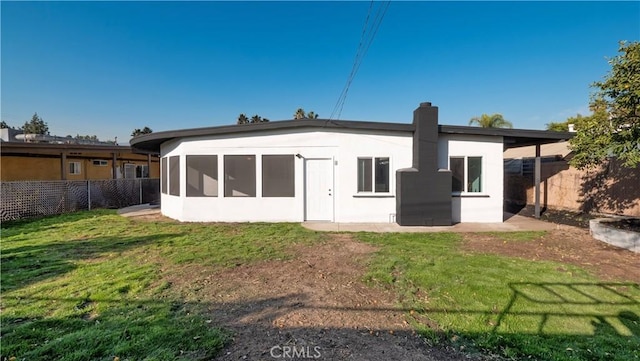 rear view of property with a yard