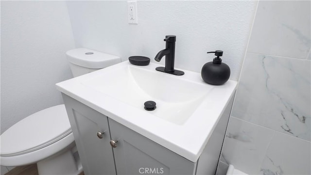 bathroom featuring toilet and vanity