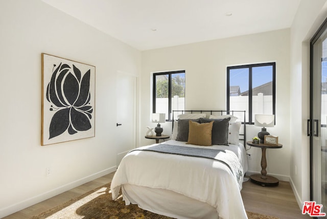 bedroom with hardwood / wood-style flooring