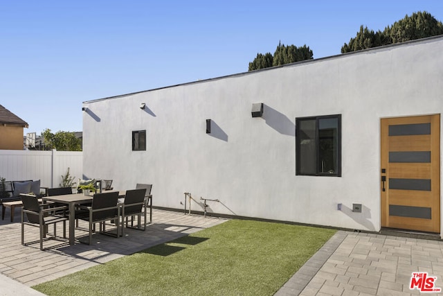 rear view of property featuring a patio area