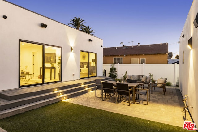 view of patio terrace at dusk