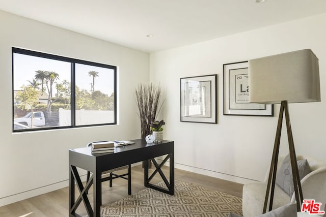 home office with light hardwood / wood-style floors