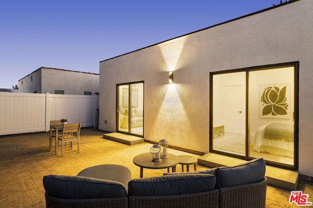 patio terrace at dusk with an outdoor living space