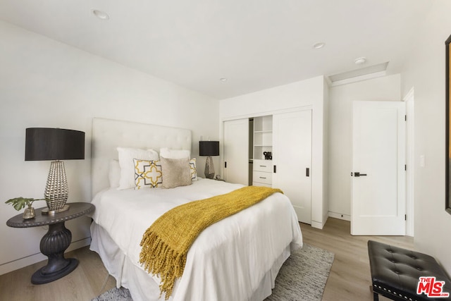 bedroom featuring a closet and light hardwood / wood-style flooring