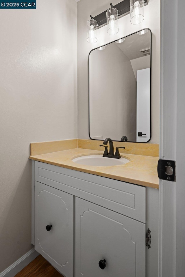 bathroom with hardwood / wood-style floors and vanity