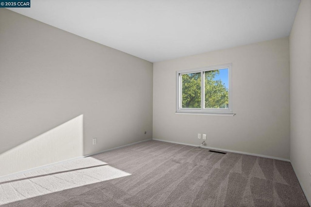 spare room with light colored carpet