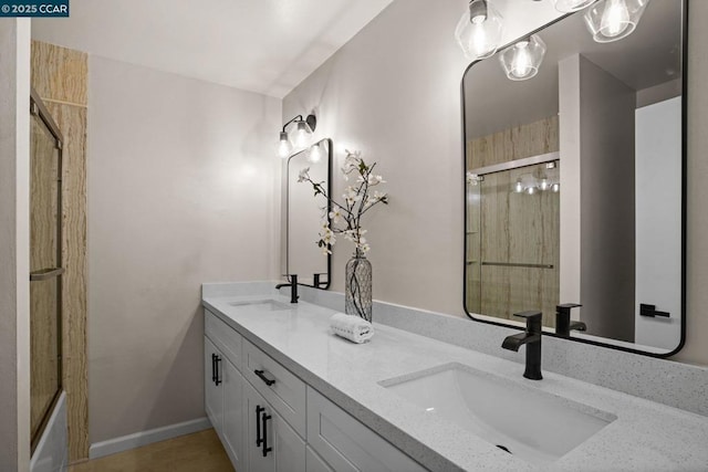 bathroom with a shower with door and vanity