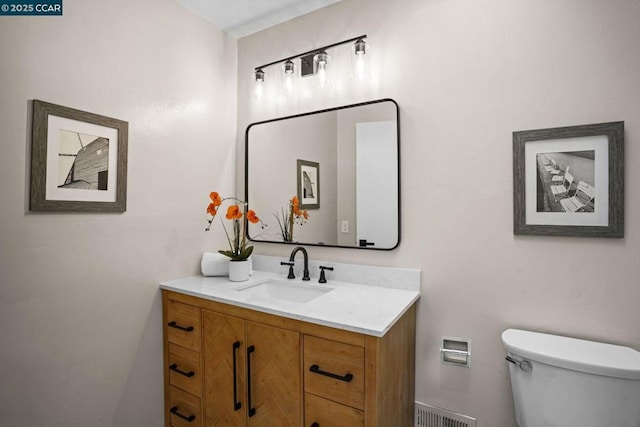 bathroom with toilet and vanity