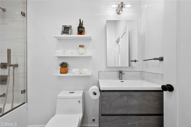 full bathroom featuring toilet, vanity, and combined bath / shower with glass door