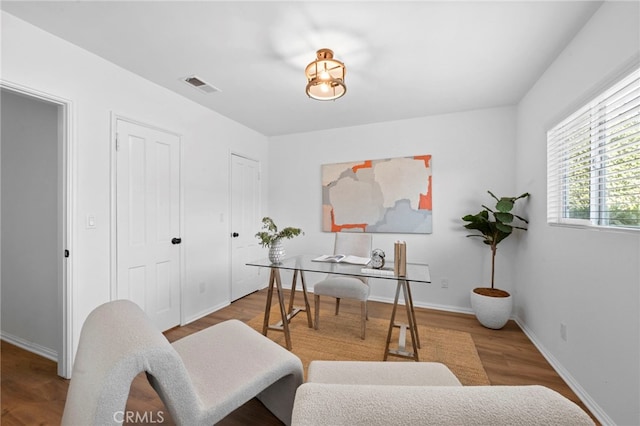 home office with hardwood / wood-style floors