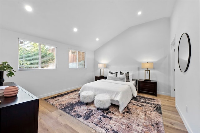 bedroom with light hardwood / wood-style flooring and lofted ceiling