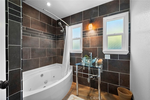 bathroom featuring tile walls and shower / tub combo with curtain