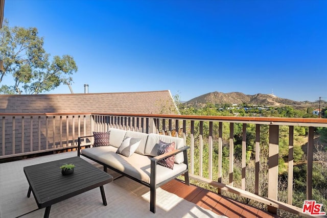 wooden terrace featuring an outdoor living space and a mountain view