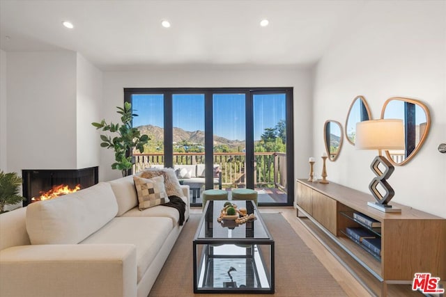 living room featuring a mountain view and hardwood / wood-style floors