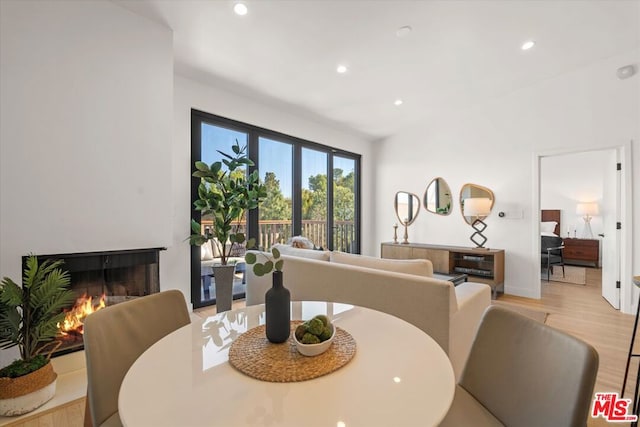 dining space with light hardwood / wood-style floors