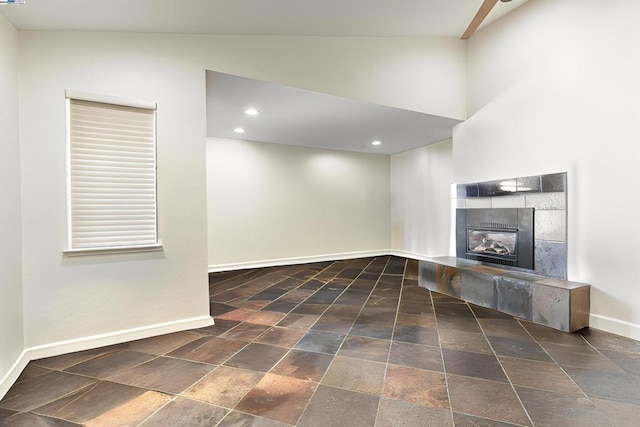 unfurnished living room featuring a fireplace and vaulted ceiling