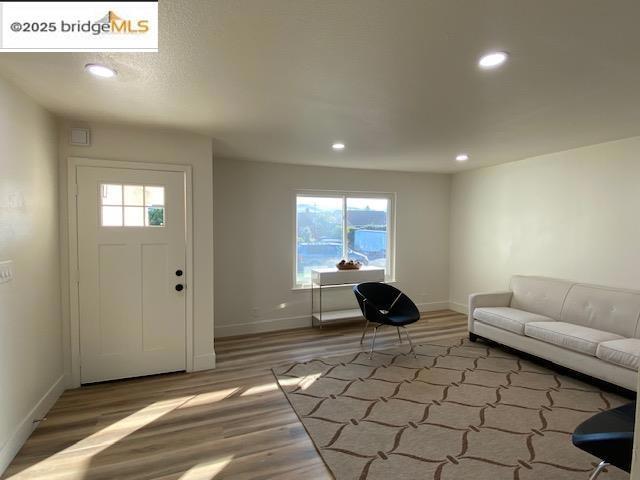 foyer entrance featuring hardwood / wood-style floors and plenty of natural light