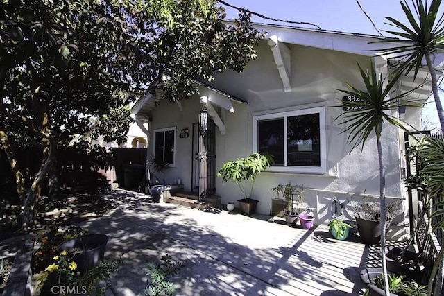 view of front of property with a patio and stucco siding