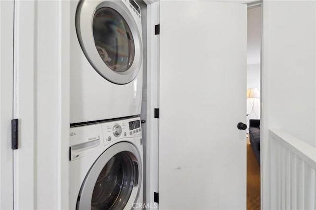 laundry area featuring stacked washer / drying machine