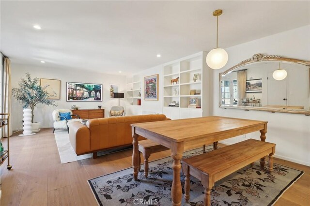 dining space featuring light hardwood / wood-style floors and built in features