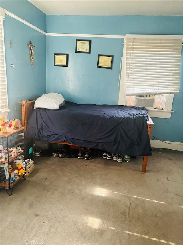 bedroom with concrete floors and cooling unit