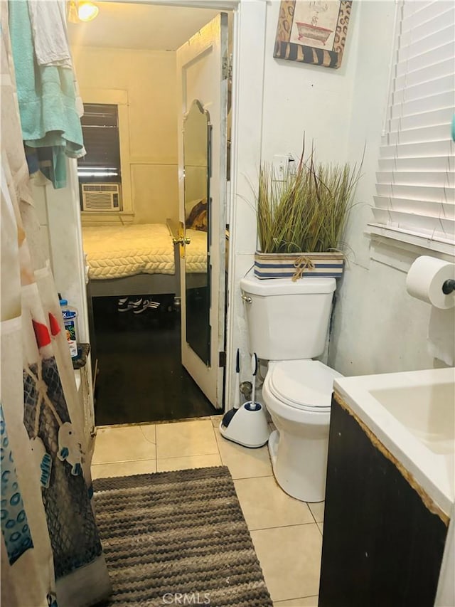 bathroom with cooling unit, tile patterned floors, vanity, and toilet