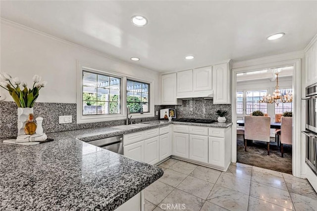 kitchen with white cabinets, black gas cooktop, and sink