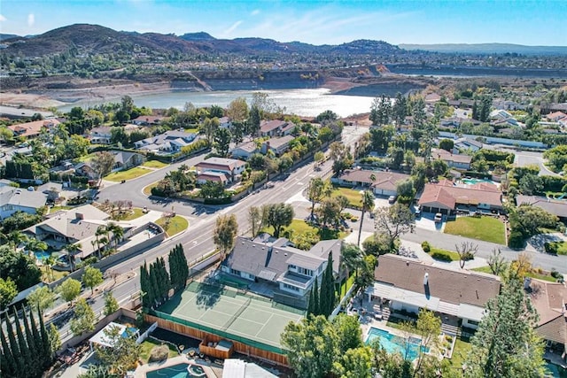 drone / aerial view featuring a water and mountain view