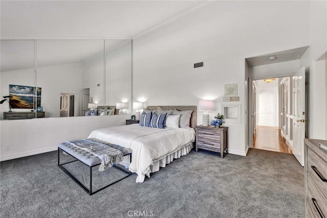 bedroom with high vaulted ceiling and carpet