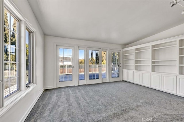 empty room featuring lofted ceiling and carpet