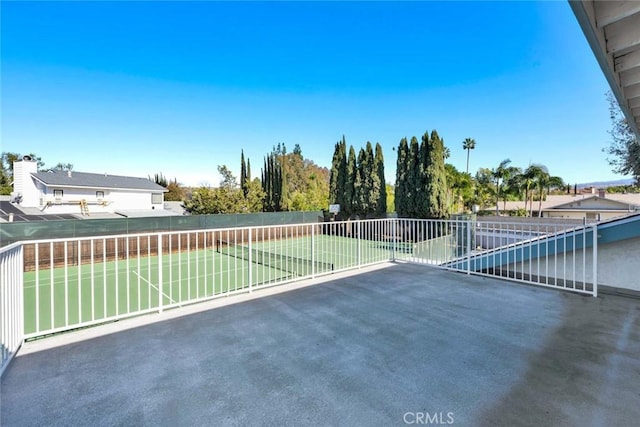 view of patio featuring tennis court