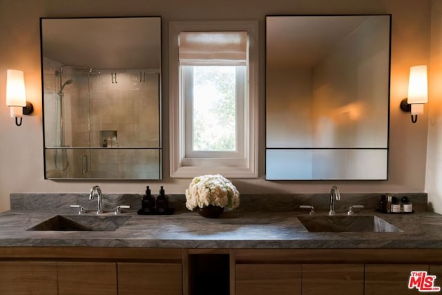 bathroom with an enclosed shower and vanity