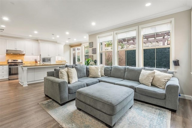 living room with hardwood / wood-style floors and crown molding