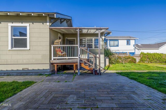 view of front facade with a patio and a front lawn