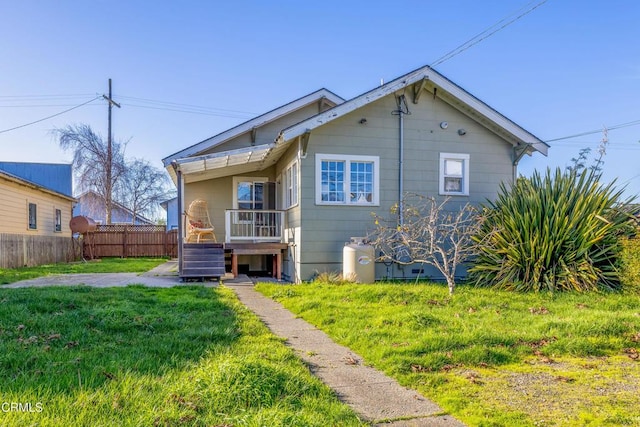 back of property featuring a lawn