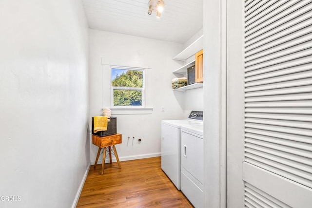 laundry area featuring light hardwood / wood-style flooring and independent washer and dryer