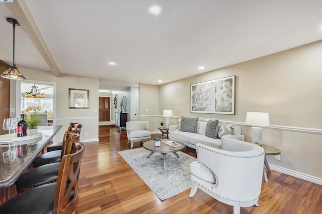 living room with hardwood / wood-style flooring and a chandelier