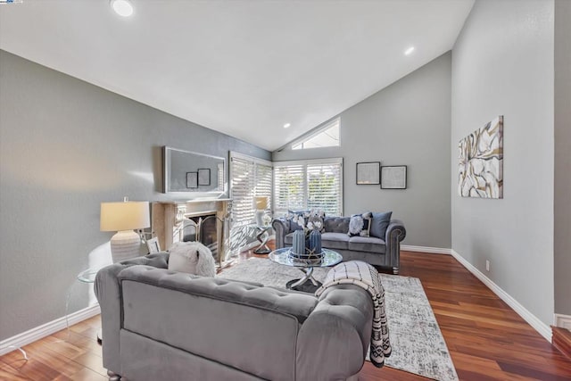 living room featuring lofted ceiling and hardwood / wood-style flooring