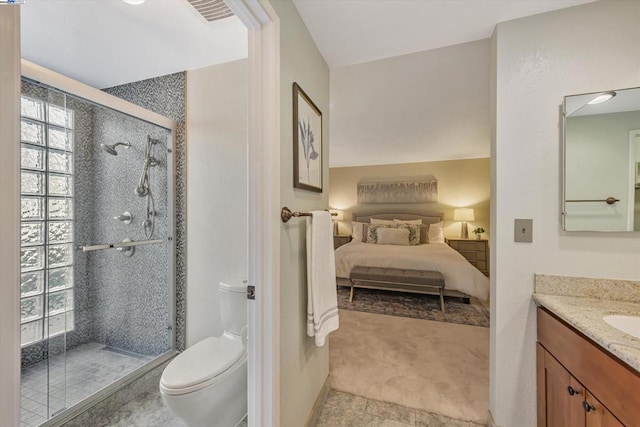 bathroom featuring toilet, vanity, and an enclosed shower