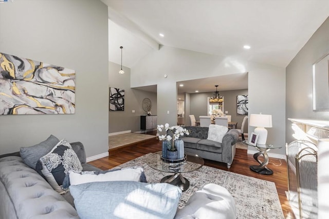 living room with vaulted ceiling with beams, an inviting chandelier, and hardwood / wood-style floors