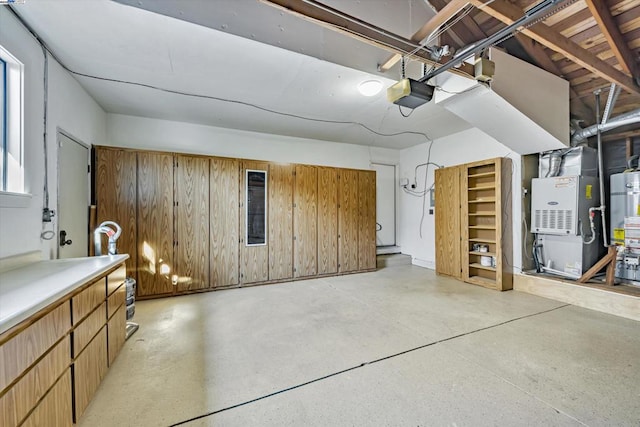 garage featuring a garage door opener, heating unit, wood walls, and gas water heater