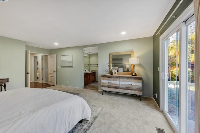 bedroom featuring access to exterior, carpet, and ensuite bathroom